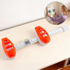 Picture hanging tool with built-in level positioning a frame straight on a wall
